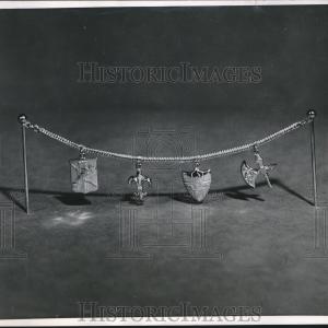 1951 Press Photo Charms on a chain attached to two stick pins - nef70197 Discount Best Place
