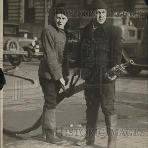 1930 Press Photo Two firefighters using fire hose View Cheap Pice